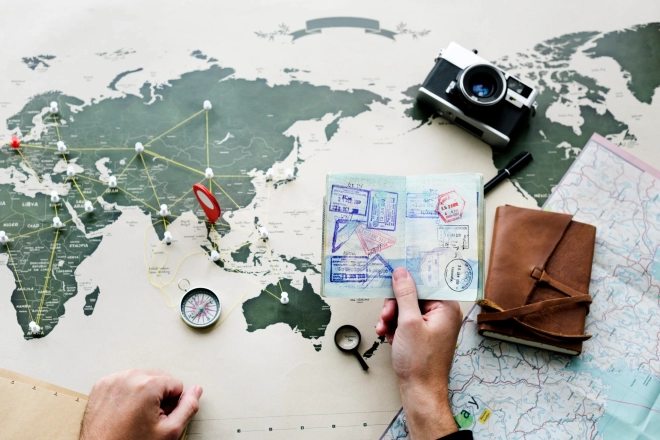 aerial-view-of-hand-holding-passport-planning-the-2022-12-16-00-56-36-utc