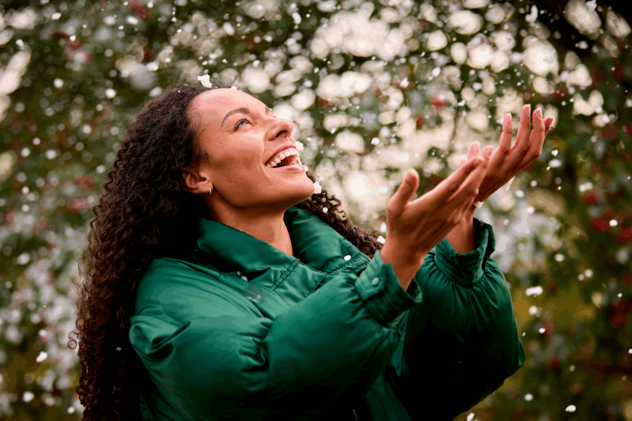 smiling-young-woman-wearing-coat-standing-outside-2023-11-27-05-24-45-utc
